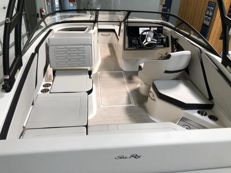 Slide: The Image of 2025 Sea Ray SPX 210 boat interior with modern seating and steering console. - 5