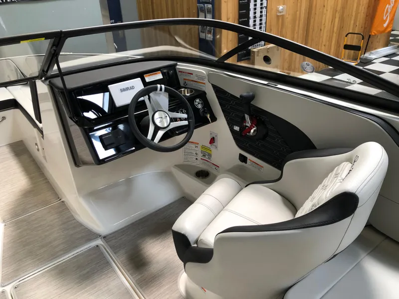 Slide: The Image of 2025 Sea Ray SPX 210 boat interior with steering wheel and control panel. - 8