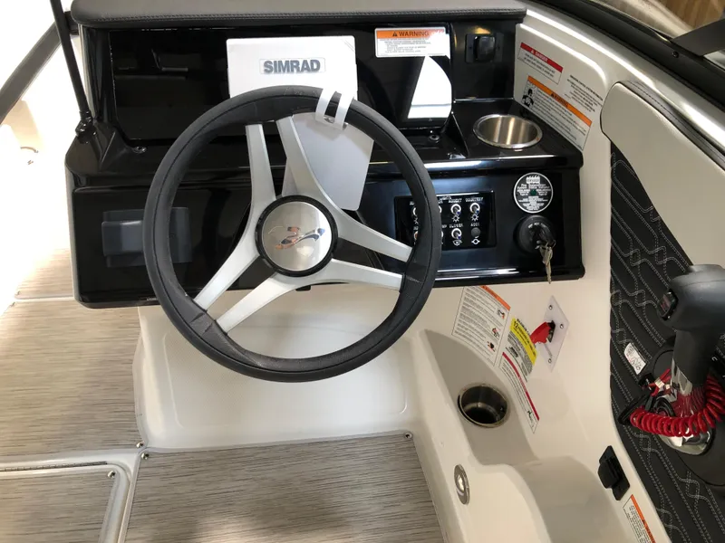 Slide: The Image of 2025 Sea Ray SPX 210 boat dashboard with steering wheel and control panel. - 9