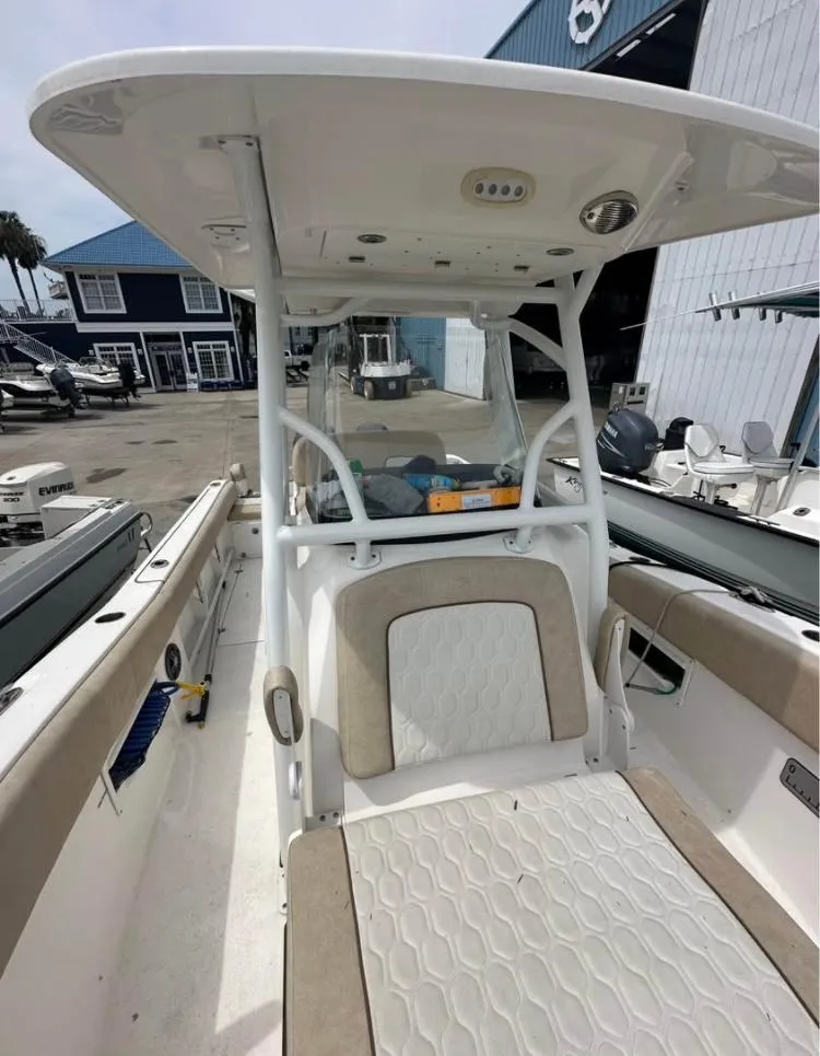 Slide: The Image of 2021 Sea Fox 268 Commander boat interior with seating and console, docked at a marina. - 6