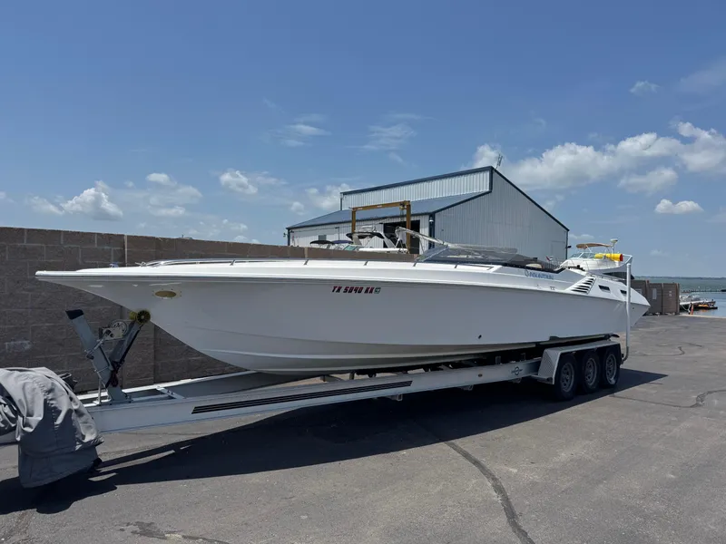 Slide: The Image of 2004 Fountain 35 Executioner speedboat on trailer, parked outdoors under clear sky. - 2