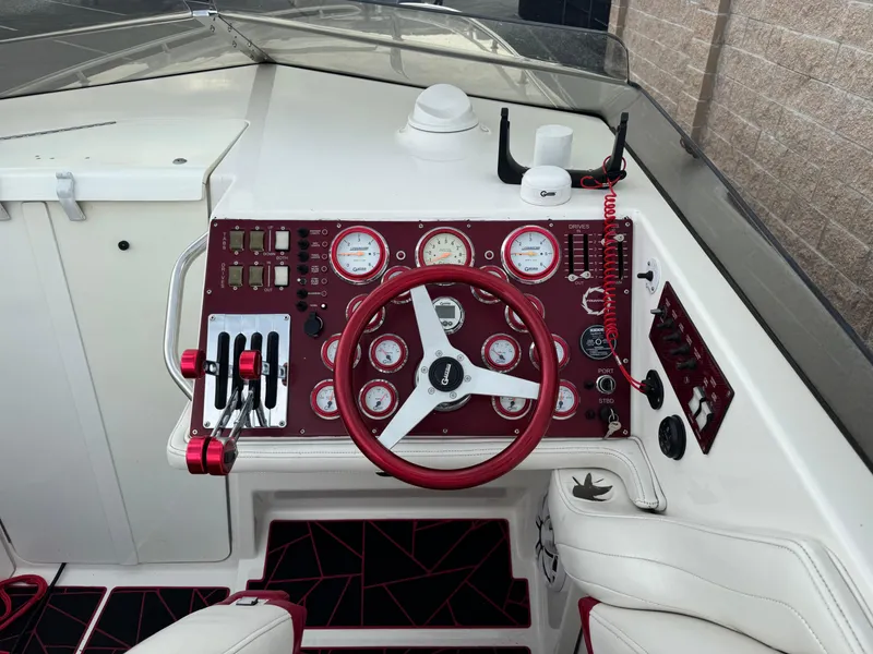 Slide: The Image of Control panel of a 2004 Fountain 35 Executioner speedboat with red accents and gauges. - 5