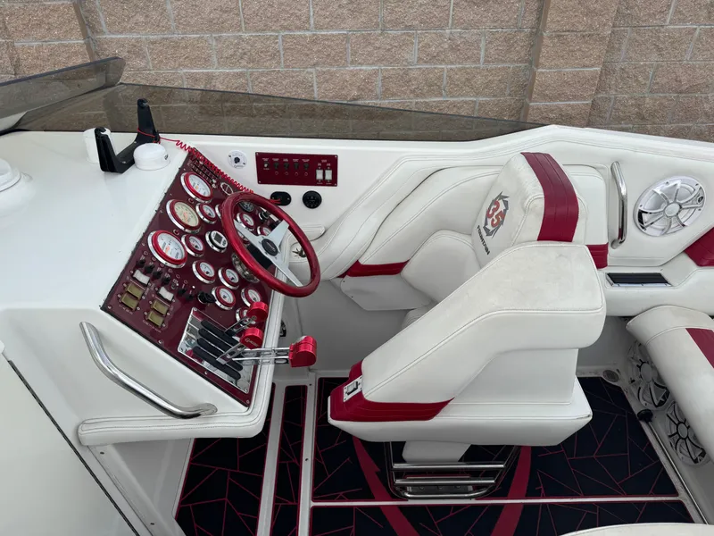 Slide: The Image of 2004 Fountain 35 Executioner boat cockpit with red and white interior, steering wheel, and control panel. - 6