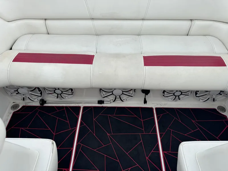 Slide: The Image of 2004 Fountain 35 Executioner boat interior with white seating, red accents, and geometric-patterned flooring. - 8