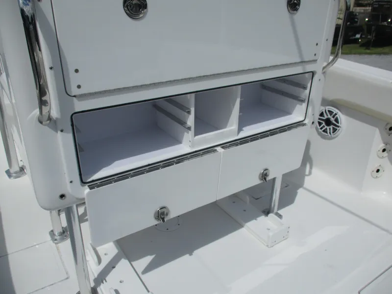 Slide: The Image of 2024 Bluewater 2850 boat storage compartments with open drawers and sleek design. - 10