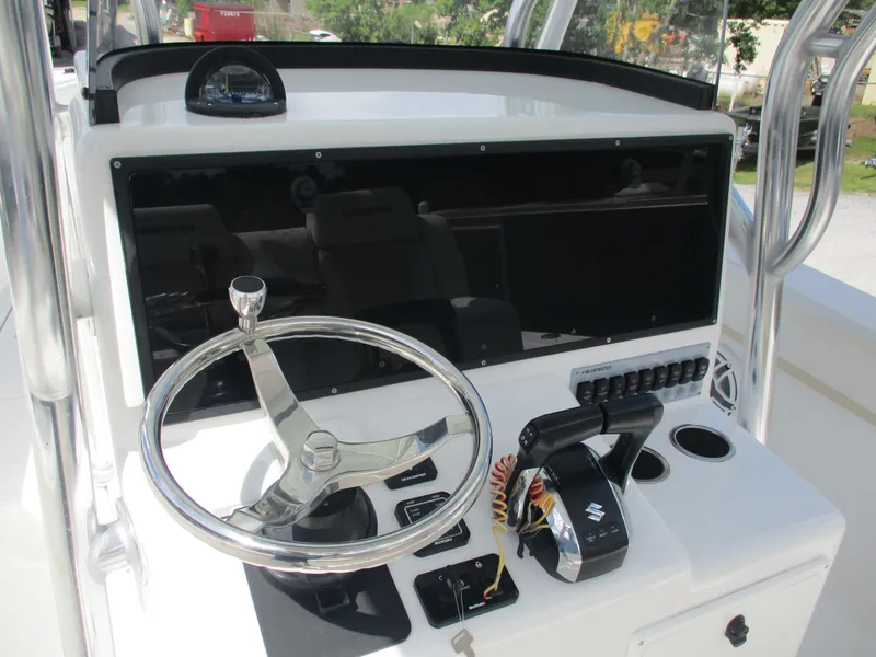 Slide: The Image of 2024 Bluewater 2850 boat helm with steering wheel and control panel. - 11