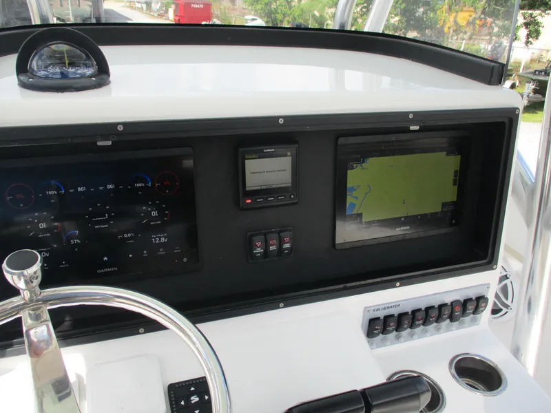 Slide: The Image of 2024 Bluewater 2850 boat dashboard with Garmin navigation and control systems. - 12