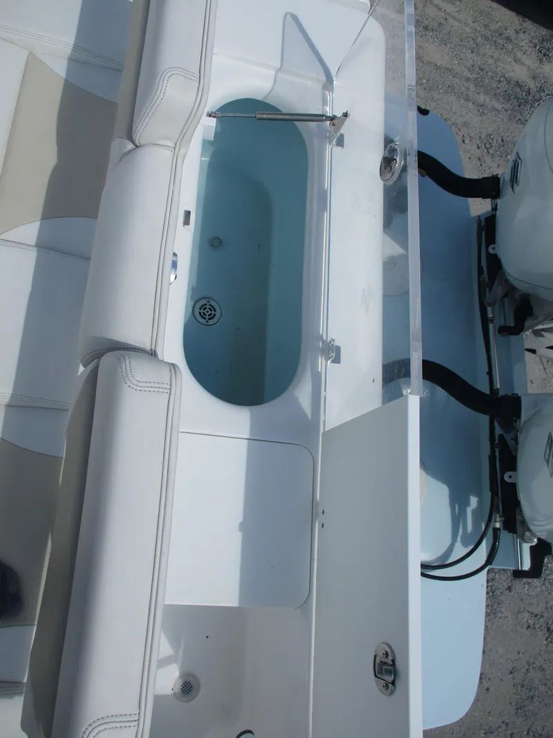 Slide: The Image of 2024 Bluewater 2850 boat with open storage compartment and seating area. - 16