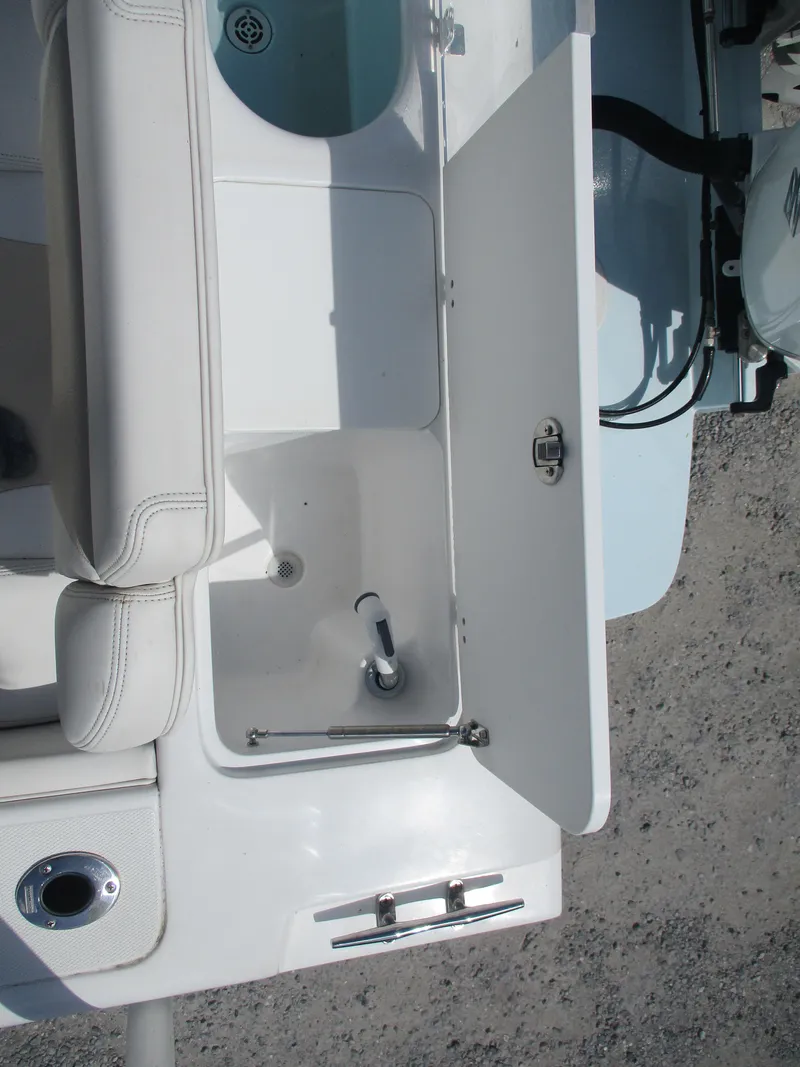 Slide: The Image of 2024 Bluewater 2850 boat interior with open storage compartment and seating. - 17