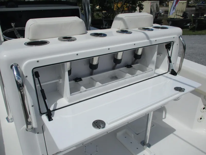 Slide: The Image of 2024 Bluewater 2850 boat with open storage compartment and cup holders. - 19