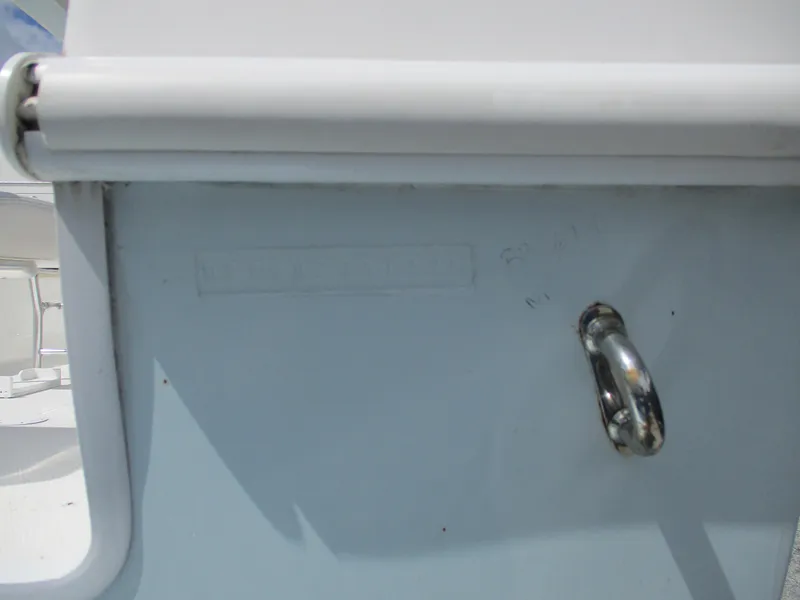 Slide: The Image of 2024 Bluewater 2850 boat detail with metal hook and white trim. - 27
