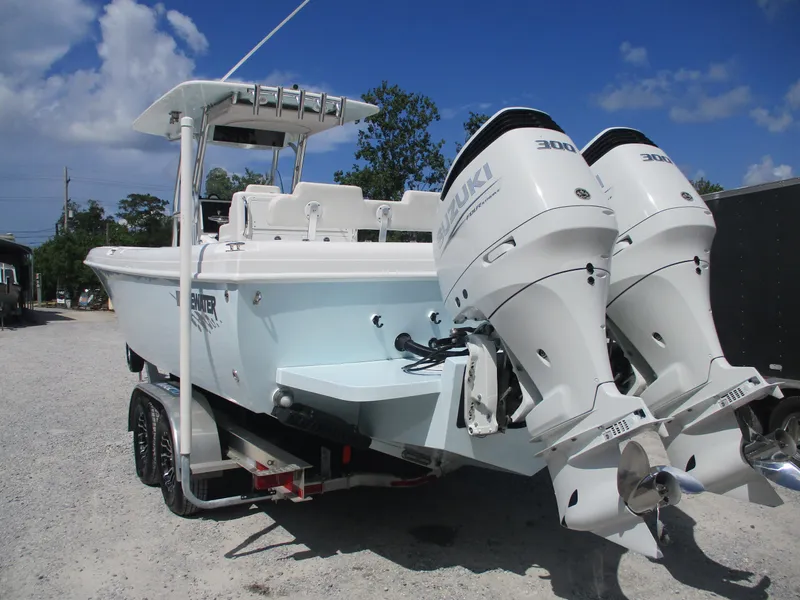 Slide: The Image of 2024 Bluewater 2850 boat with dual Suzuki 300 engines on a trailer. - 4