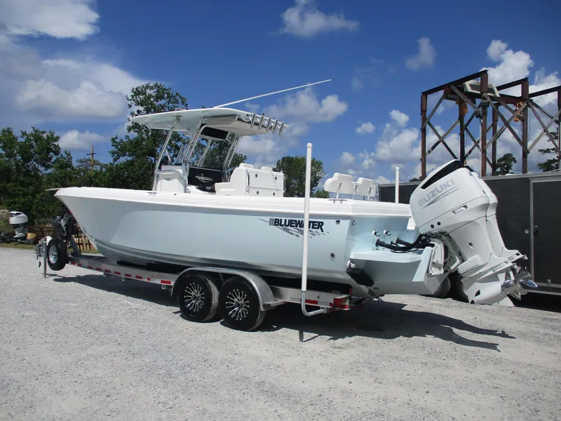 Slide: The Image of 2024 Bluewater 2850 boat on trailer, featuring dual Suzuki outboard engines. - 5
