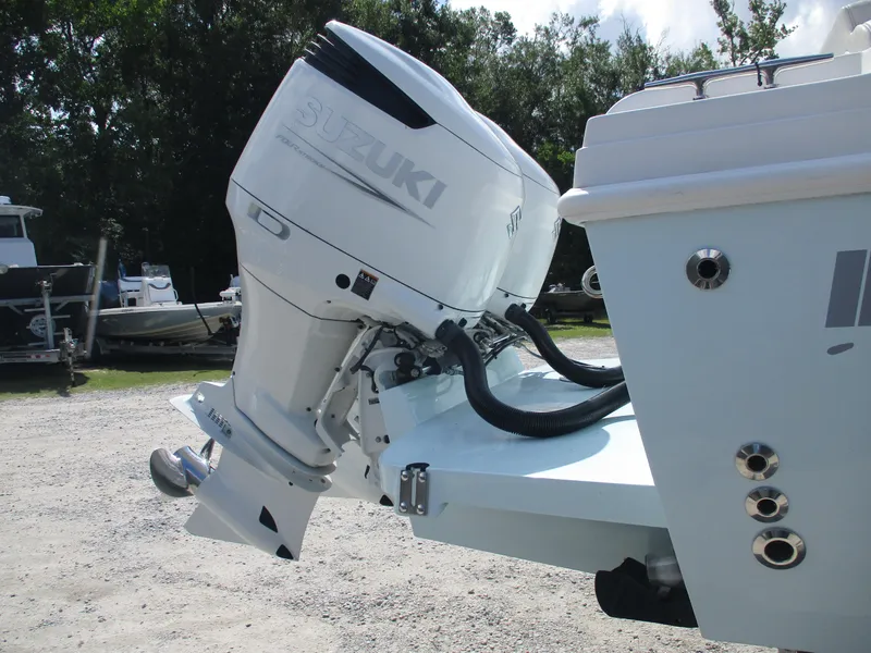 Slide: The Image of 2024 Bluewater 2850 boat with Suzuki outboard motor in a sunny outdoor setting. - 8