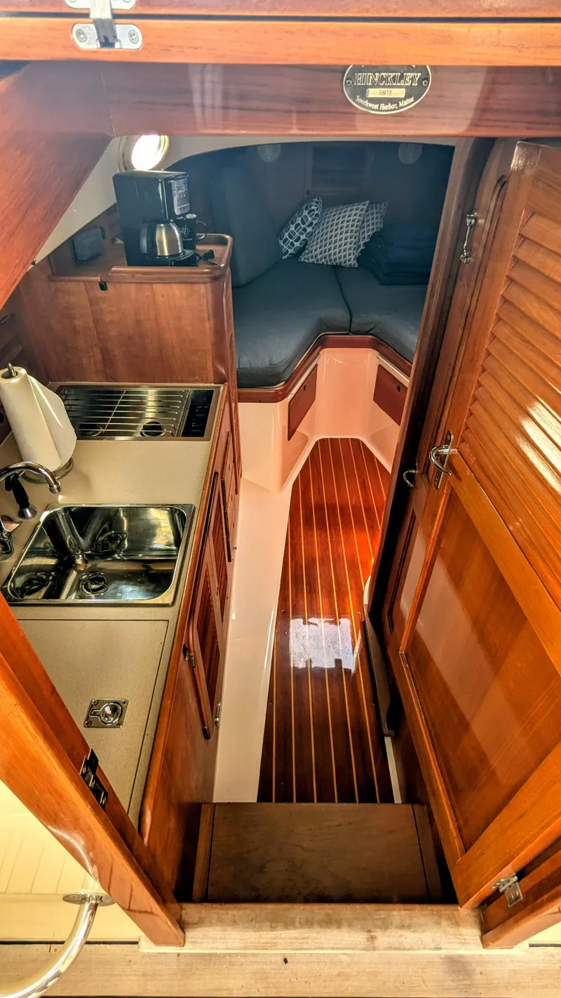Slide: The Image of Interior of 2000 Hinckley Picnic Boat with kitchenette and cozy sleeping area. - 7