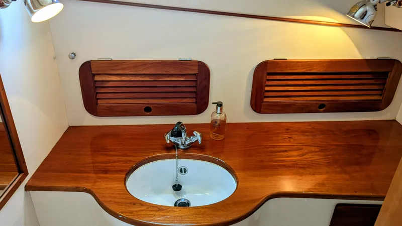 Slide: The Image of Hinckley Picnic Boat 2000 interior with wooden countertop and sink. - 11