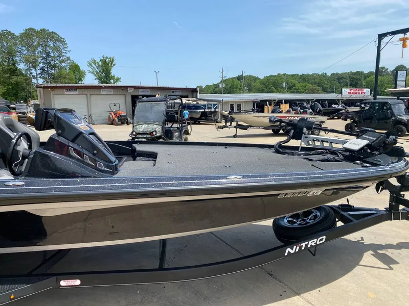 Slide: The Image of 2024 Nitro Z20 Pro boat displayed at a dealership with various vehicles in the background. - 3