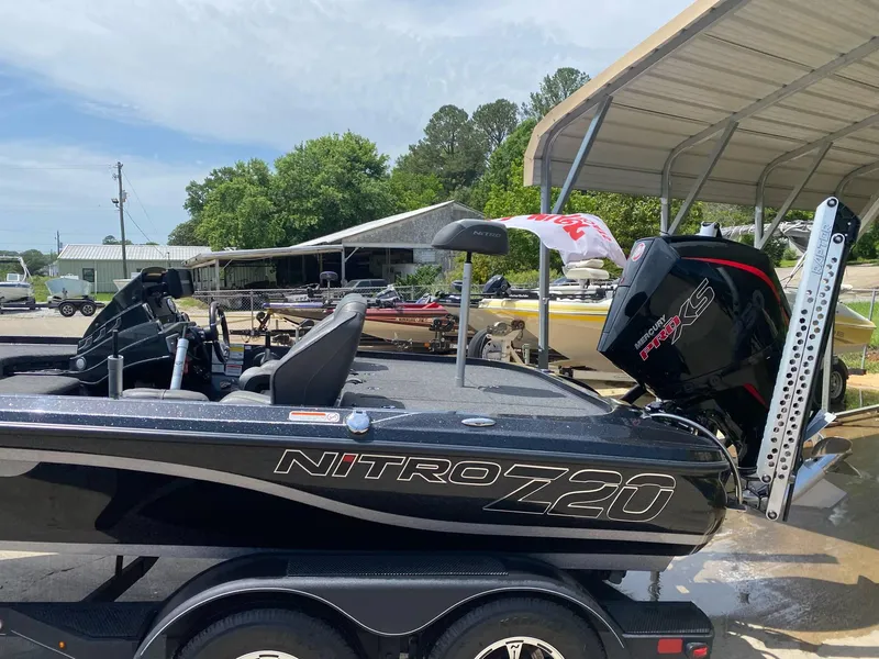 Slide: The Image of 2024 Nitro Z20 Pro boat with Mercury Pro XS engine, parked under a canopy. - 5
