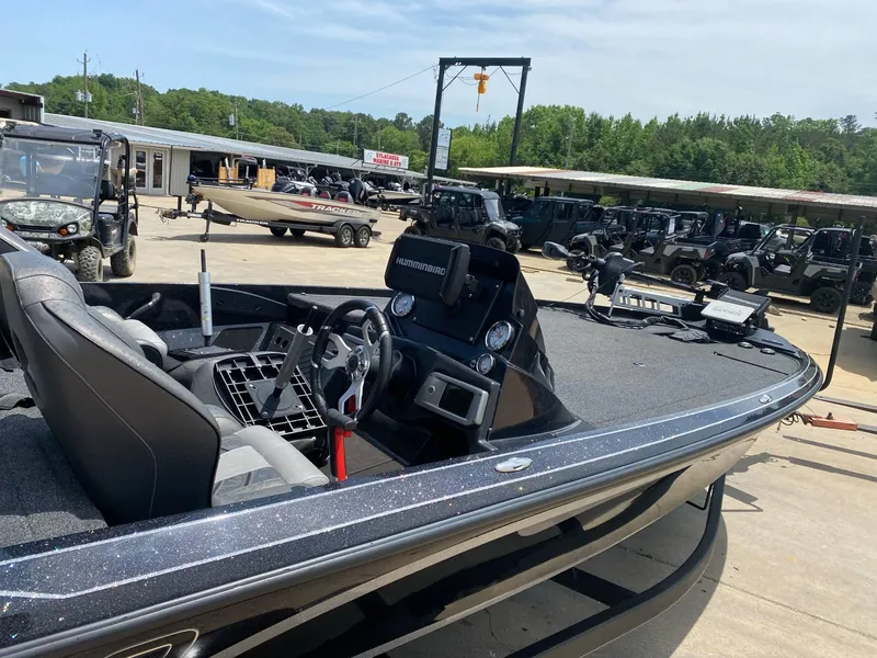 Slide: The Image of 2024 Nitro Z20 Pro boat with sleek design, parked outdoors near off-road vehicles. - 6