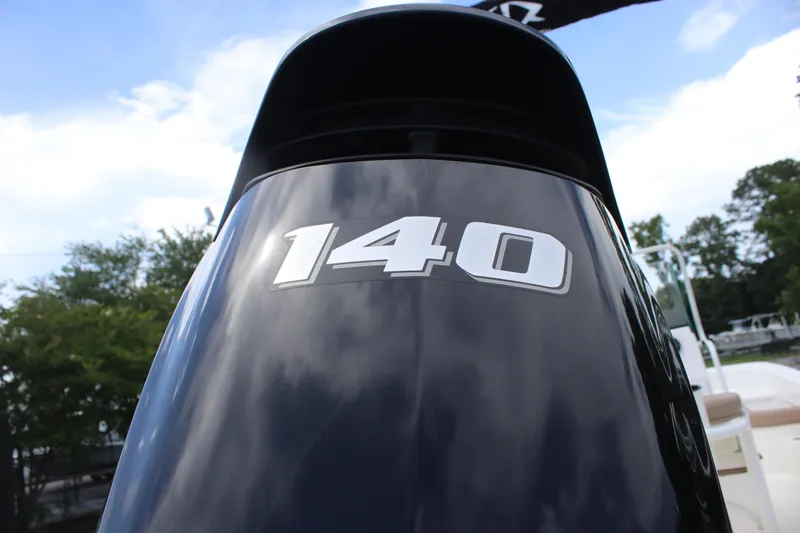 Slide: The Image of Outboard motor with "140" label on a 2022 Sundance DX22 boat. - 8