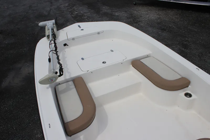 Slide: The Image of 2022 Sundance DX22 boat interior with seating and storage compartments. - 9