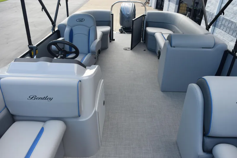 Slide: The Image of 2026 Bentley Pontoons Bolt interior with gray seating and steering console. - 15