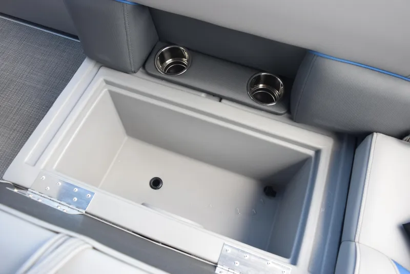 Slide: The Image of 2026 Bentley Pontoons Bolt storage compartment with cup holders and gray upholstery. - 17