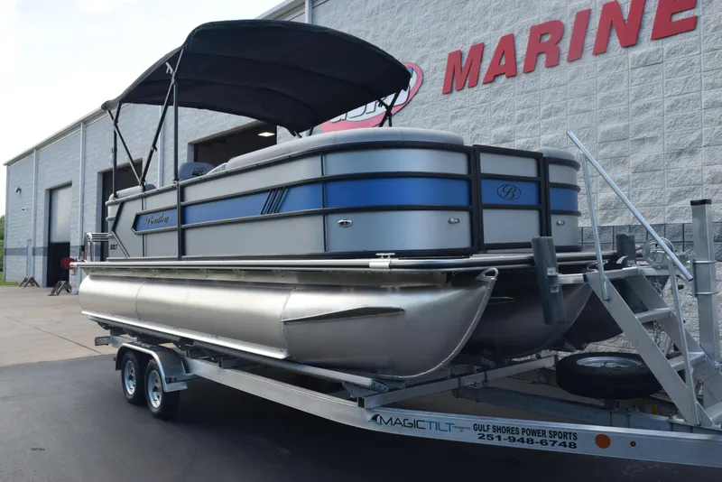 Slide: The Image of 2026 Bentley Pontoons Bolt on trailer at marine dealership. - 2
