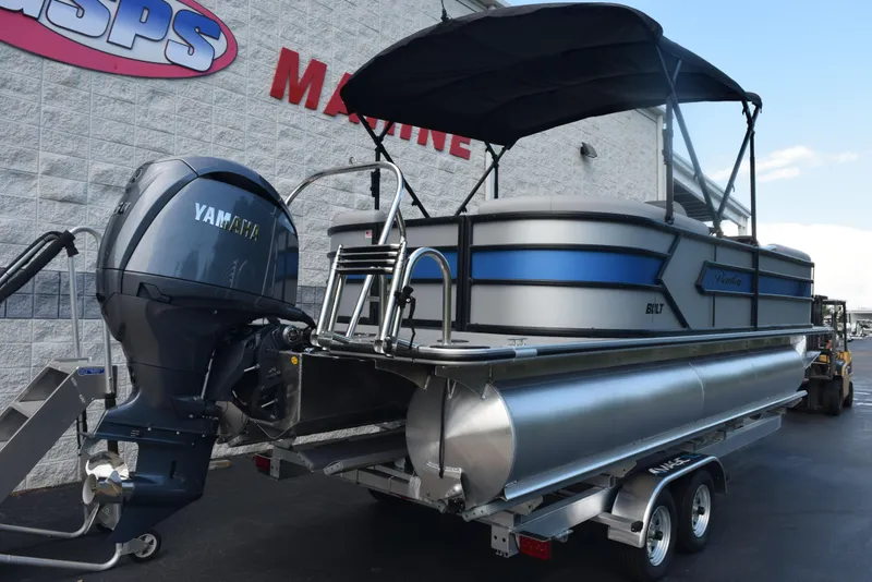 Slide: The Image of 2026 Bentley Pontoons Bolt with Yamaha engine on trailer, outside marine store. - 4