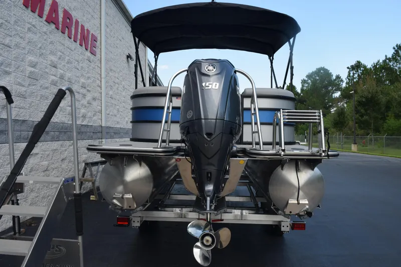 Slide: The Image of 2026 Bentley Pontoons Bolt with Yamaha 150 engine, parked outside a marine store. - 5