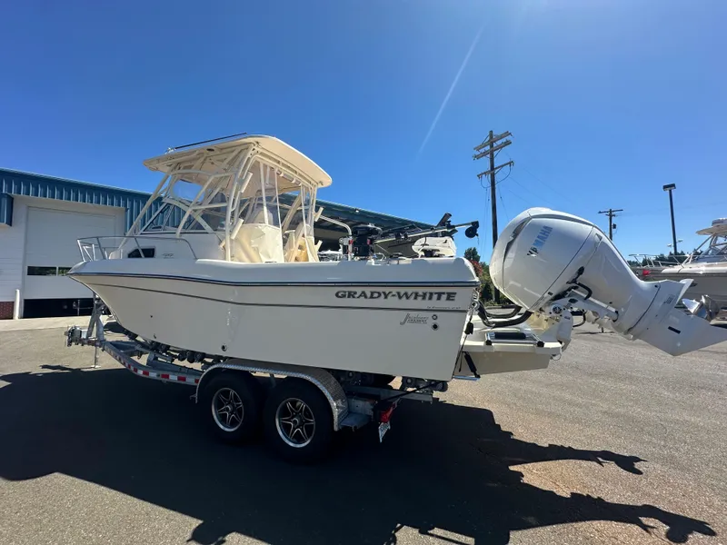Slide: The Image of 2024 Grady-White 232 Gulfstream boat on trailer, parked outdoors under clear blue sky. - 11
