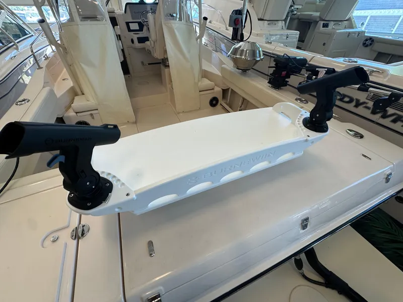 Slide: The Image of 2024 Grady-White 232 Gulfstream boat interior with rod holders and seating. - 13