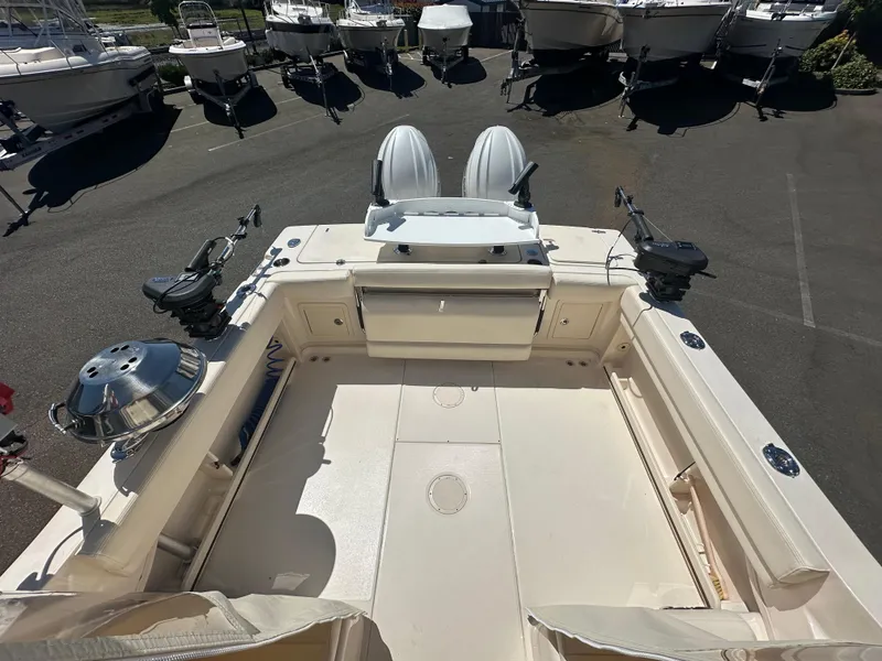 Slide: The Image of 2024 Grady-White 232 Gulfstream boat deck with fishing equipment and seating. - 6