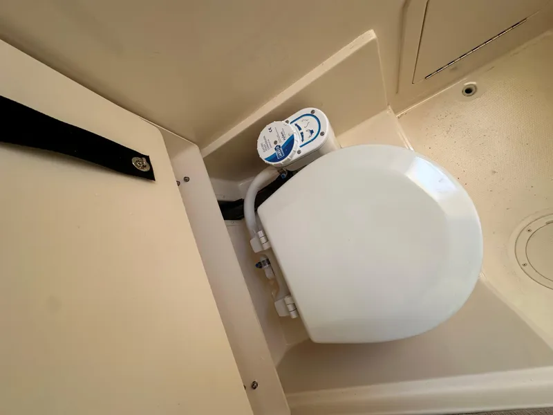 Slide: The Image of 2024 Grady-White 232 Gulfstream boat interior with compact marine toilet. - 9