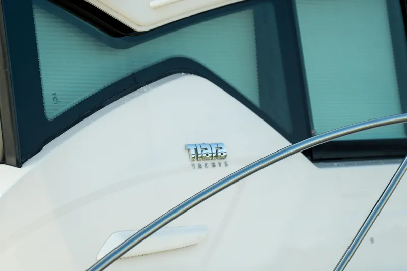 Slide: The Image of 2017 Tiara Yachts C44 Coupe, close-up of logo and window detail. - 36