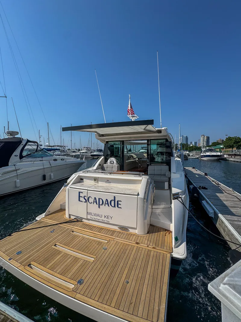 Slide: The Image of 2017 Tiara Yachts C44 Coupe docked at marina, rear view. - 38