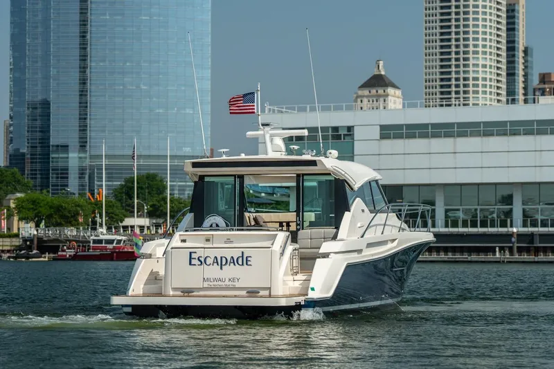 Slide: The Image of 2017 Tiara Yachts C44 Coupe cruising near city skyline. - 4