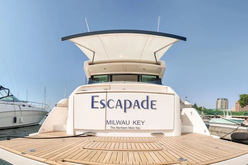 Slide: The Image of 2017 Tiara Yachts C44 Coupe named "Escapade" docked in a marina. - 40
