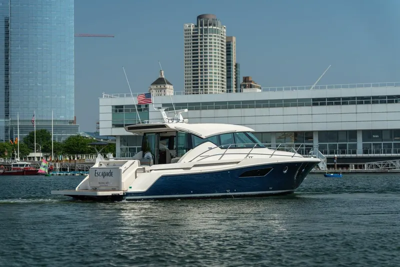 Slide: The Image of 2017 Tiara Yachts C44 Coupe on water near urban skyline. - 9