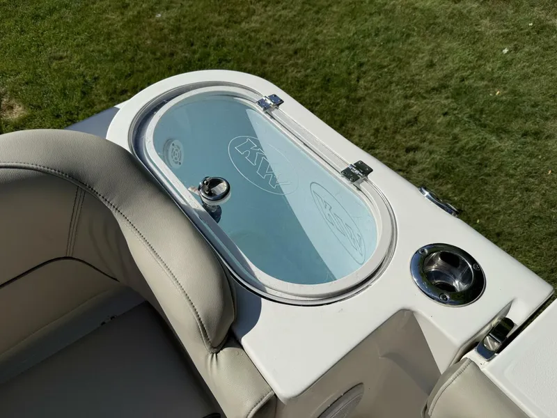 Slide: The Image of 2023 Key West 263 FS boat detail with cushioned seating and storage compartment. - 13
