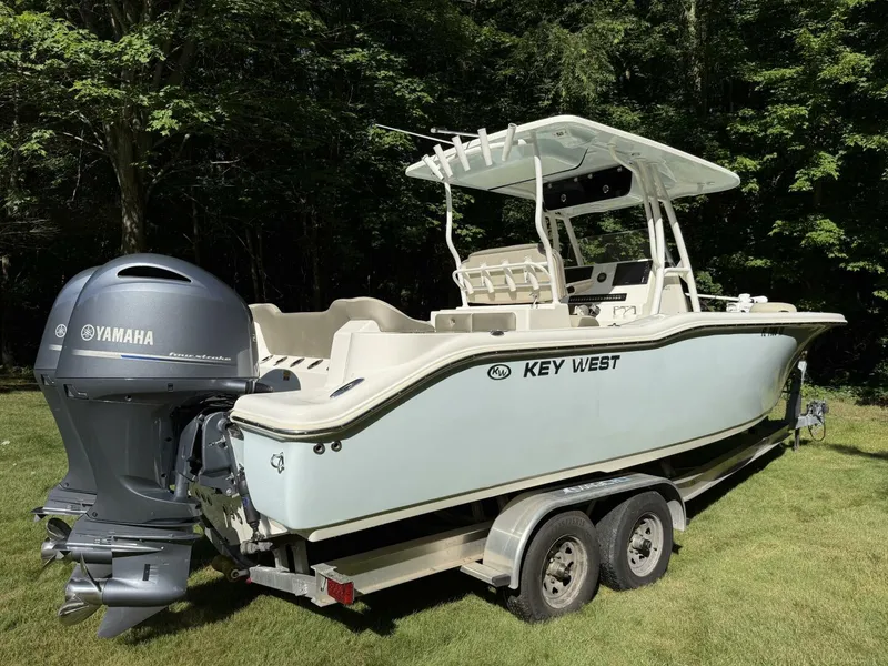 Slide: The Image of 2023 Key West 263 FS boat with Yamaha engine on trailer, parked on grass. - 3