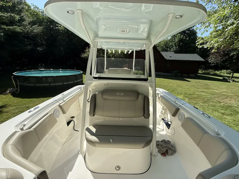 Slide: The Image of 2023 Key West 263 FS boat interior with seating, located in a grassy backyard. - 32