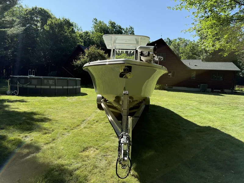 Slide: The Image of 2023 Key West 263 FS boat on trailer in grassy yard near house. - 5