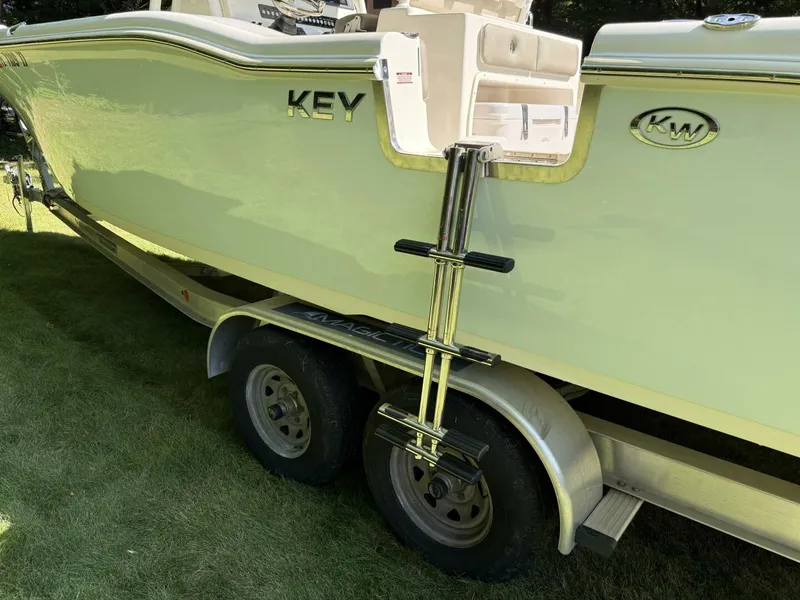 Slide: The Image of 2023 Key West 263 FS boat on trailer with ladder, parked on grass. - 8