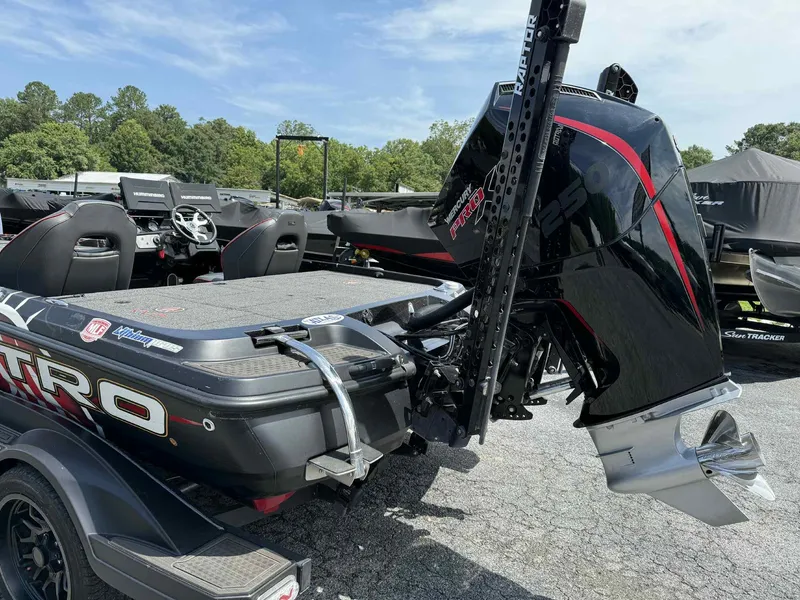 Slide: The Image of 2023 Nitro Z21 XL Pro boat with powerful Mercury engine, parked outdoors. - 2