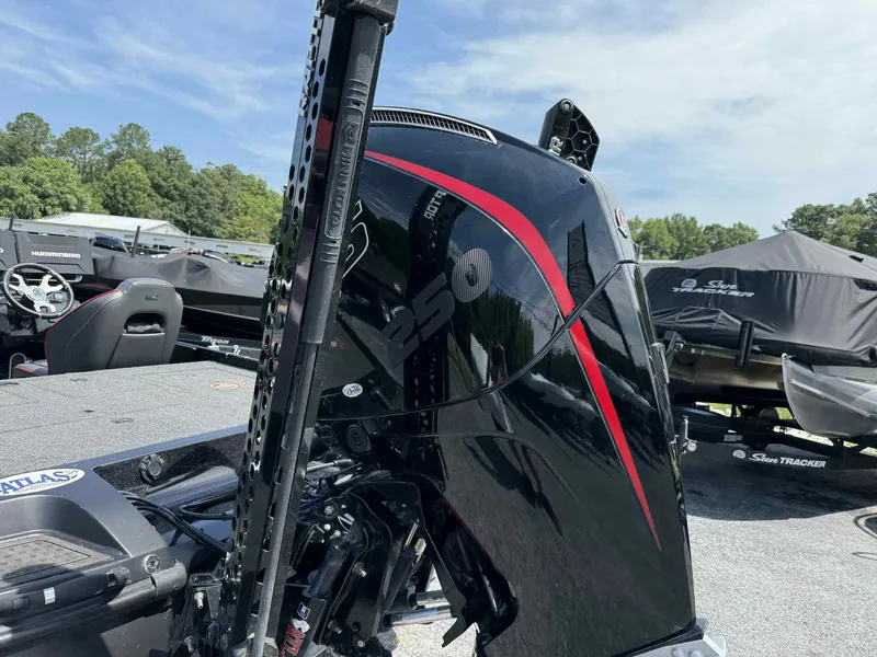 Slide: The Image of 2023 Nitro Z21 XL Pro boat engine with red accents, parked outdoors. - 5