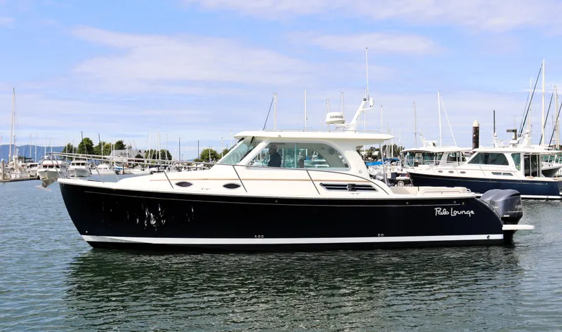 The Image of 2020 Back Cove 34O boat docked in marina, side view. - 0