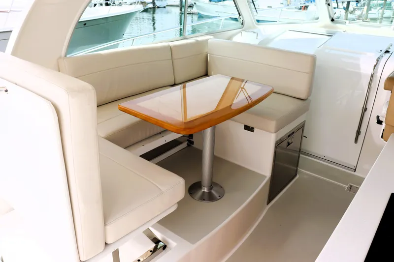 Slide: The Image of Luxurious seating area on a 2020 Back Cove 34O yacht with elegant wooden table. - 11