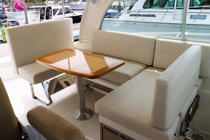 Slide: The Image of 2020 Back Cove 34O yacht interior with white seating and wooden table. - 12
