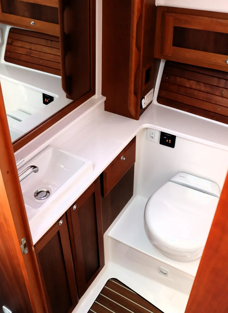 Slide: The Image of Luxurious bathroom in 2020 Back Cove 34O yacht with wooden cabinetry and modern fixtures. - 23